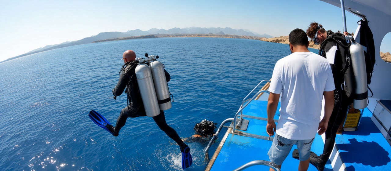 Diver taking a giant stride from a Camel day boat into the Red Sea