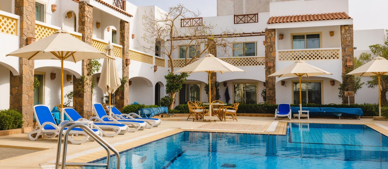 Hotel pool and white rooms on the Naama Bay campus